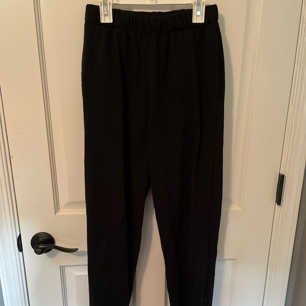 Black sweatpants cuffed at the bottom